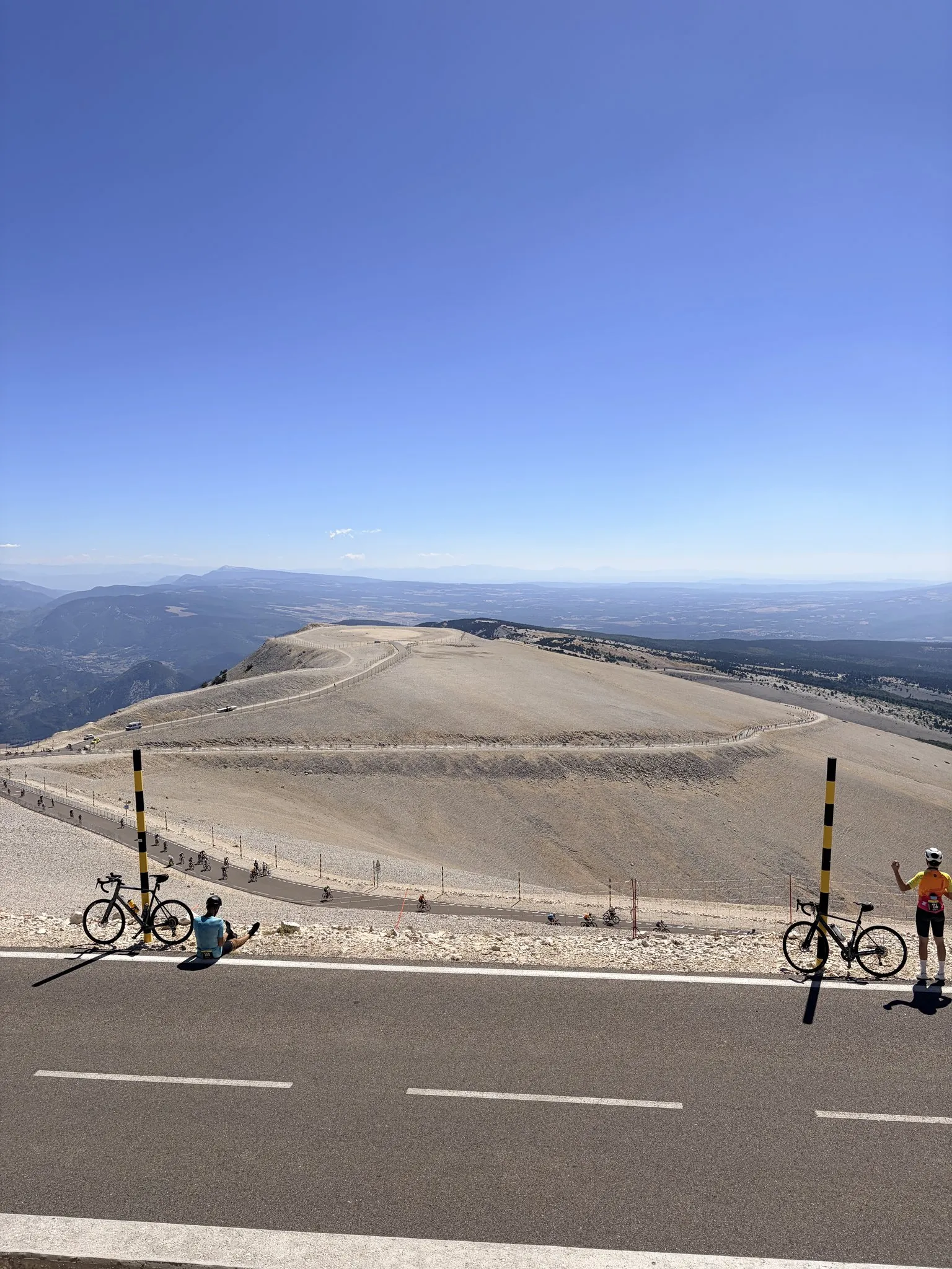 Riders at the top of Mont Ventoux, above the bald limestone dome.